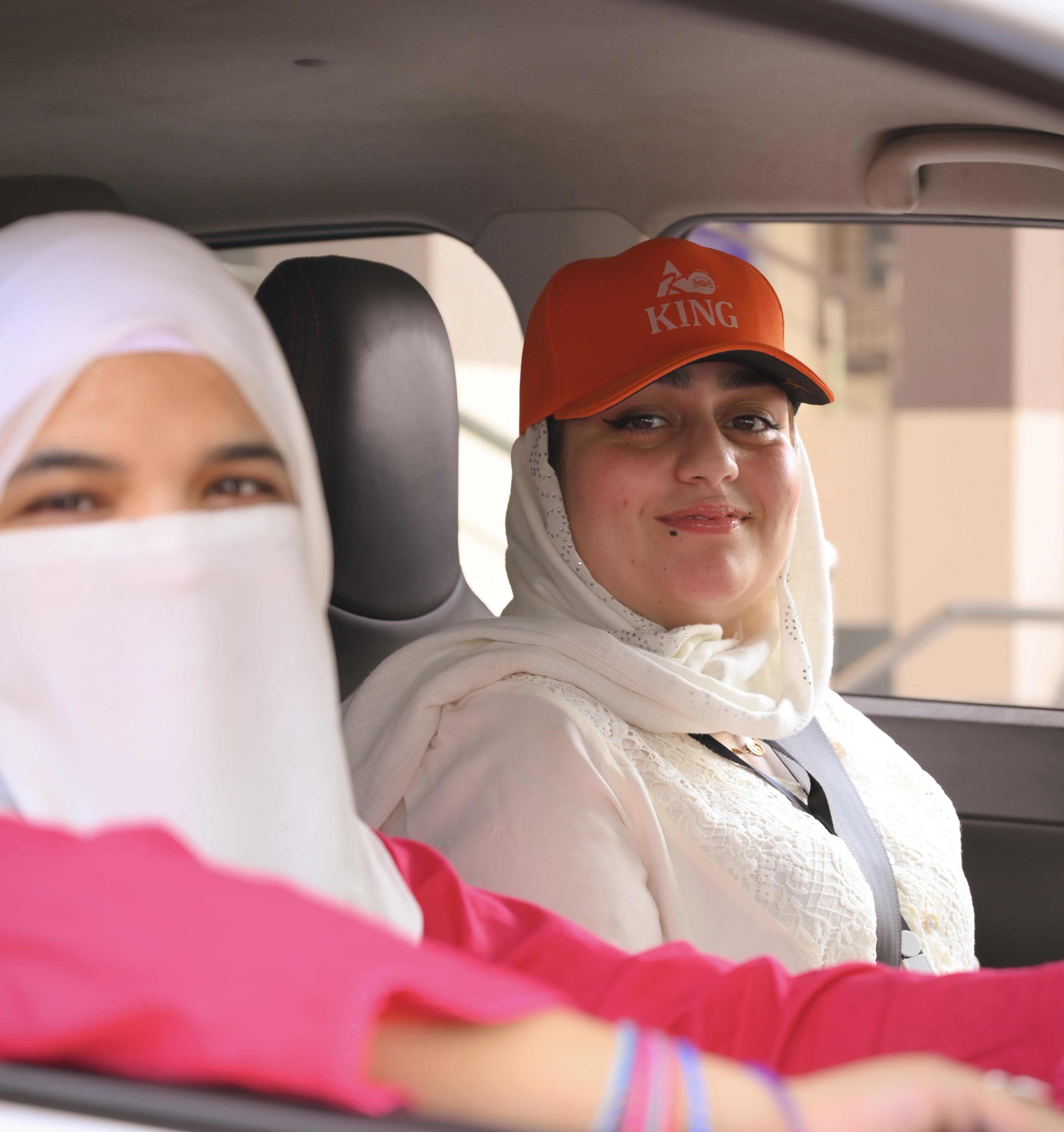 Female student driving a King Driving School car with her lady instructor in Islamabad & Rawalpindi